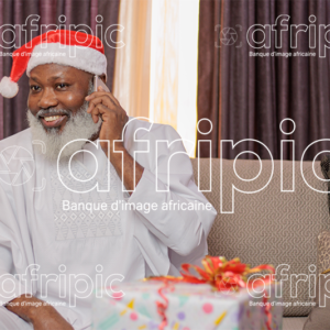 Homme africain senior, heureux en communication téléphonique, en période de fête