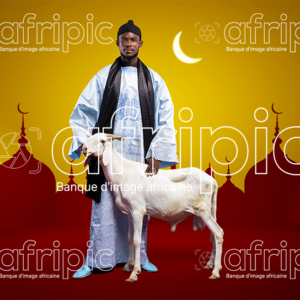 Jeune homme africain en tenue traditionnelle, avec son mouton de Tabaski