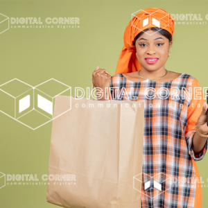 Jeune femme africaine souriante, en tenue traditionnelle. Concept achat et vente en ligne